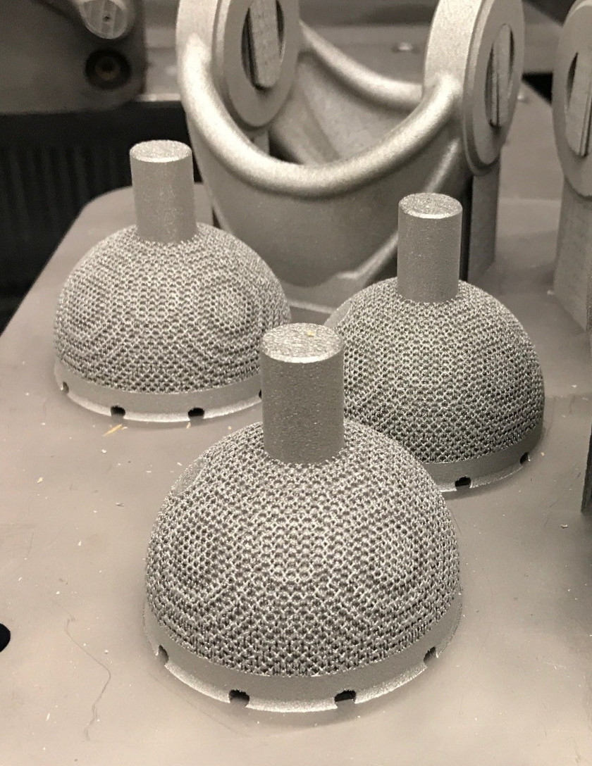 Hip cups on a build plate with cavities for powder removal Hip cups on a build plate with cavities for powder removal